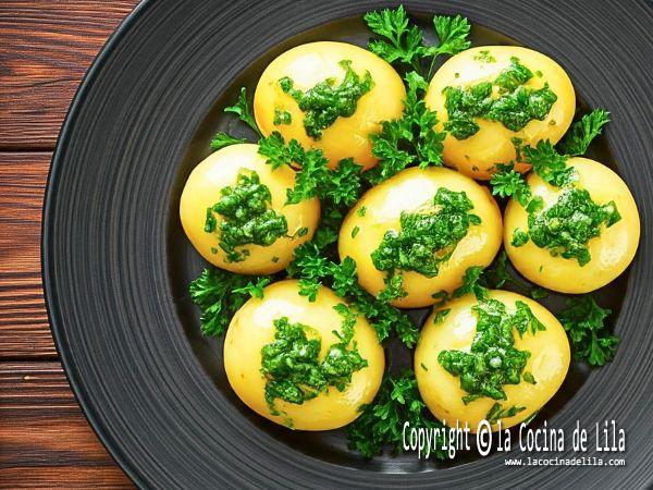 Patatas al microondas cocidas y aliñadas con ajo y perejil, lista para servir como guarnición saludable.